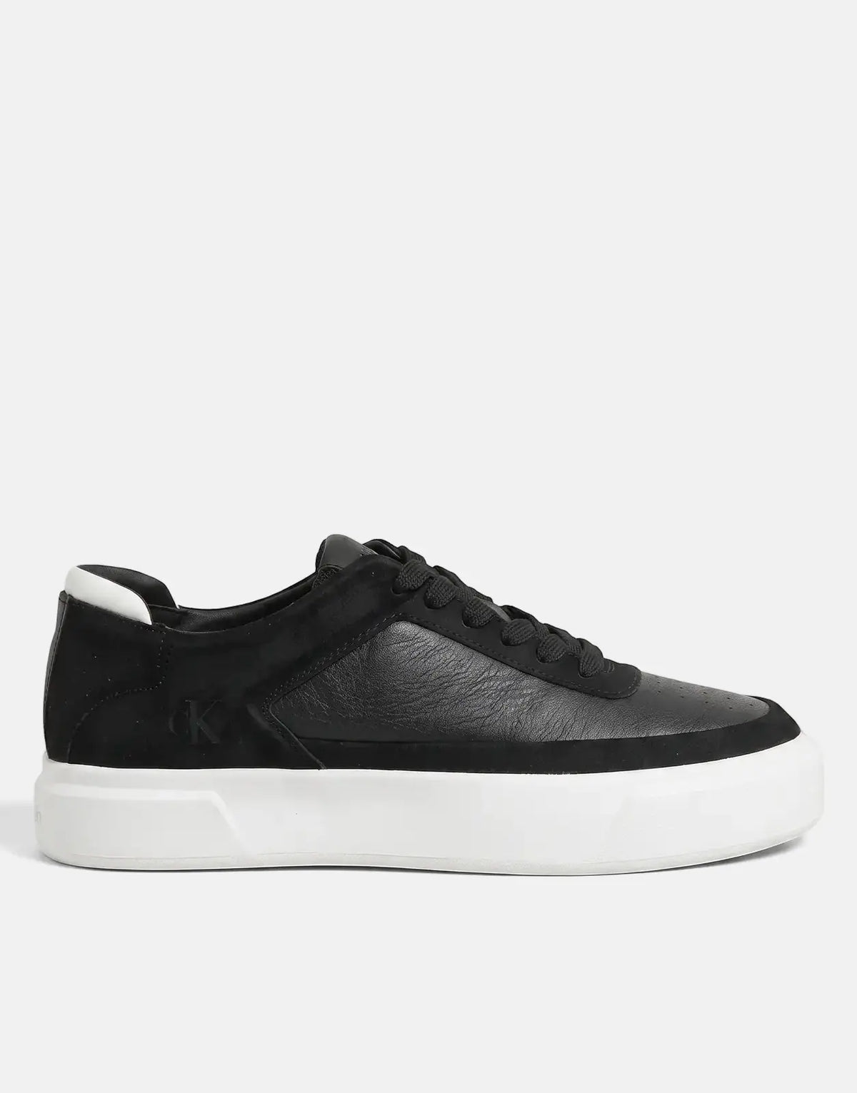 Black Calvin Klein Basket Pro sneakers with a thick white platform sole and contrasting material panels, viewed from the