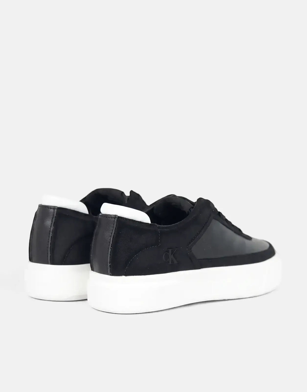 Black Calvin Klein Basket Pro sneakers with white platform soles, shown from a rear-quarter view.