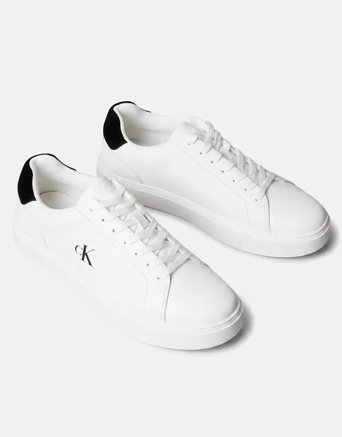 Pair of white Calvin Klein Classic Cupsole sneakers with black heel accents and white laces, displayed on a clean surface.
