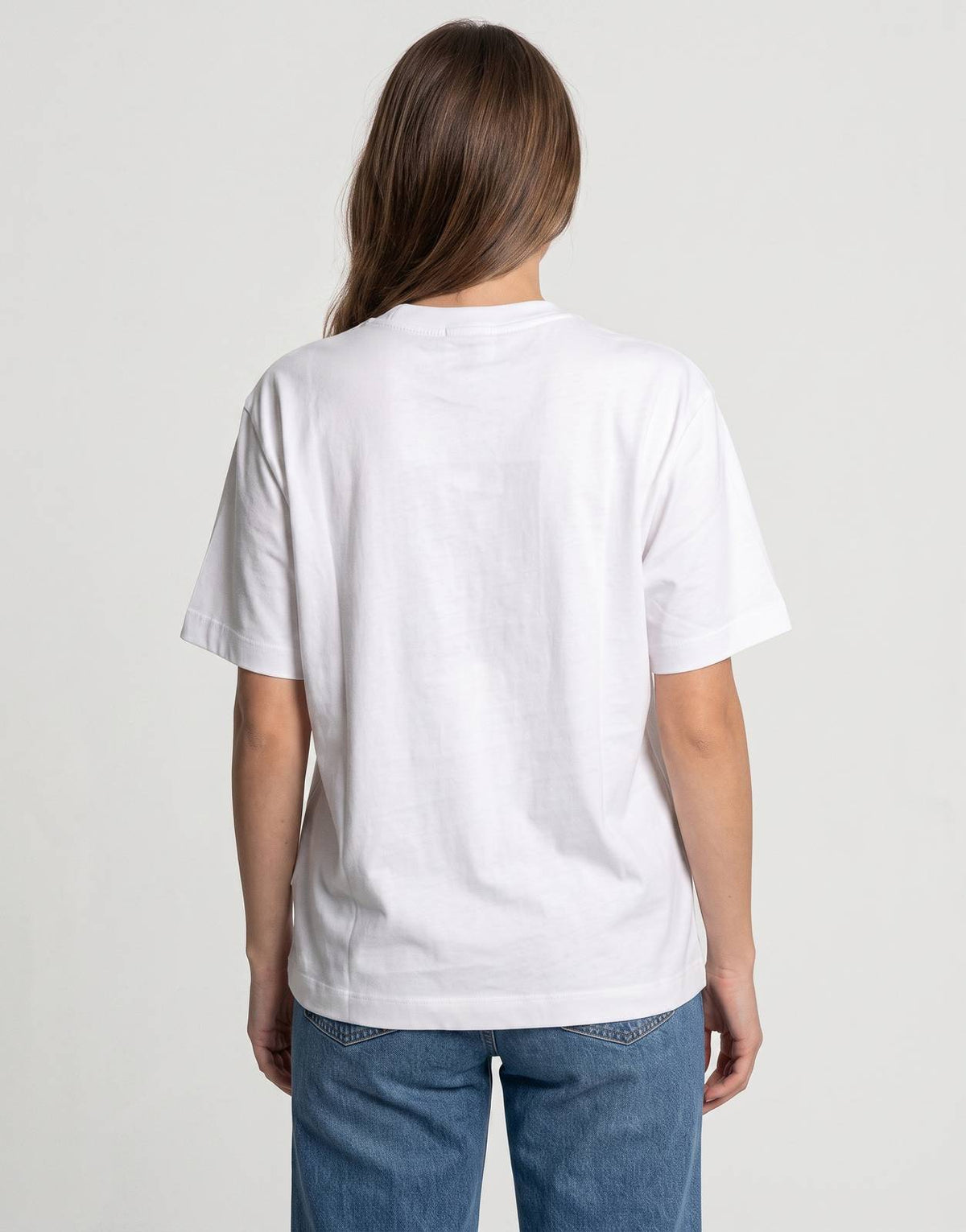 Back view of a white Calvin Klein Flower Boxy T-Shirt. This casual tee features a relaxed fit and soft cotton fabric.