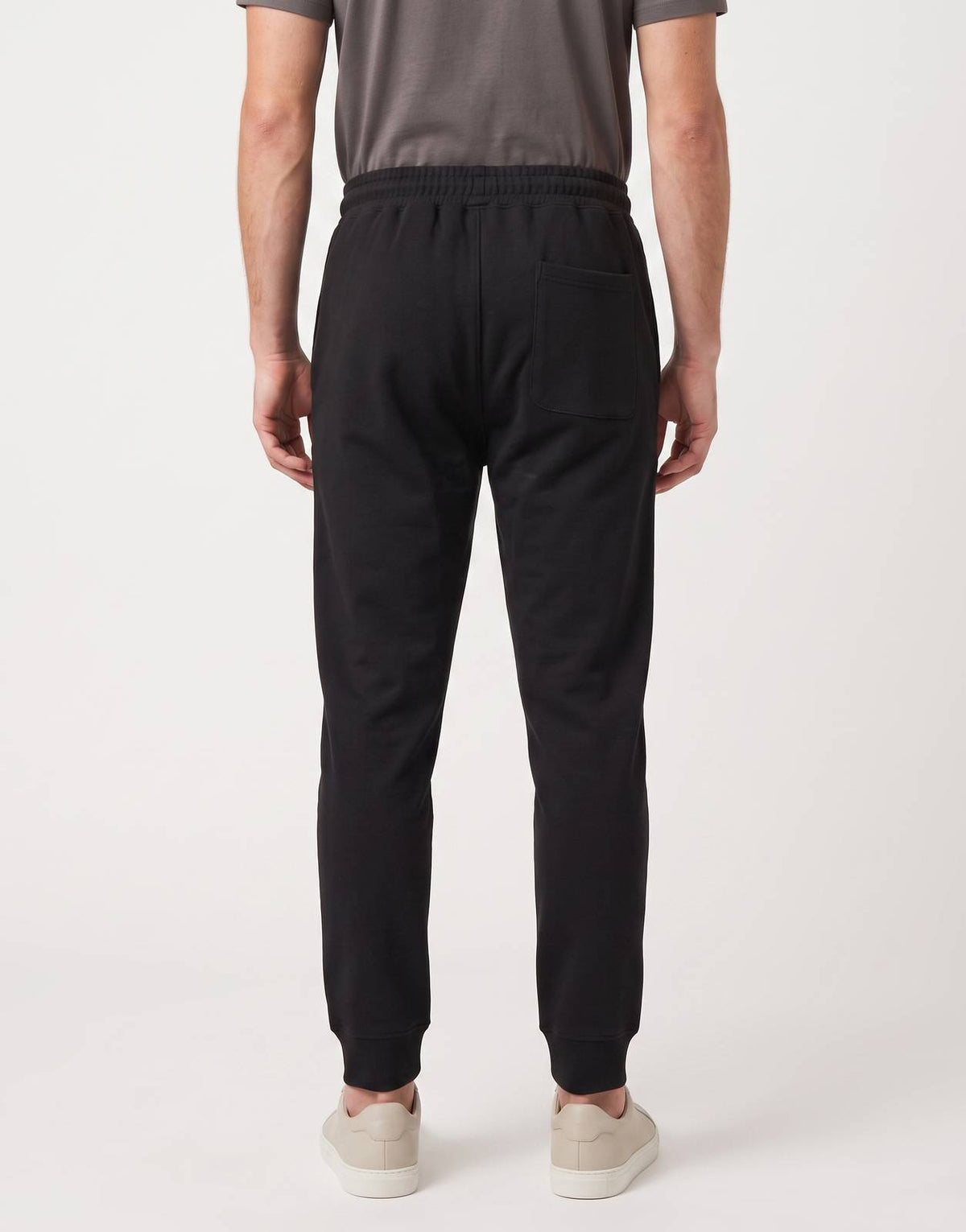 Covali Italiano-Sp Sweatpants in black, shown from the back on a male model, featuring an elasticated waist and cuffed hems.