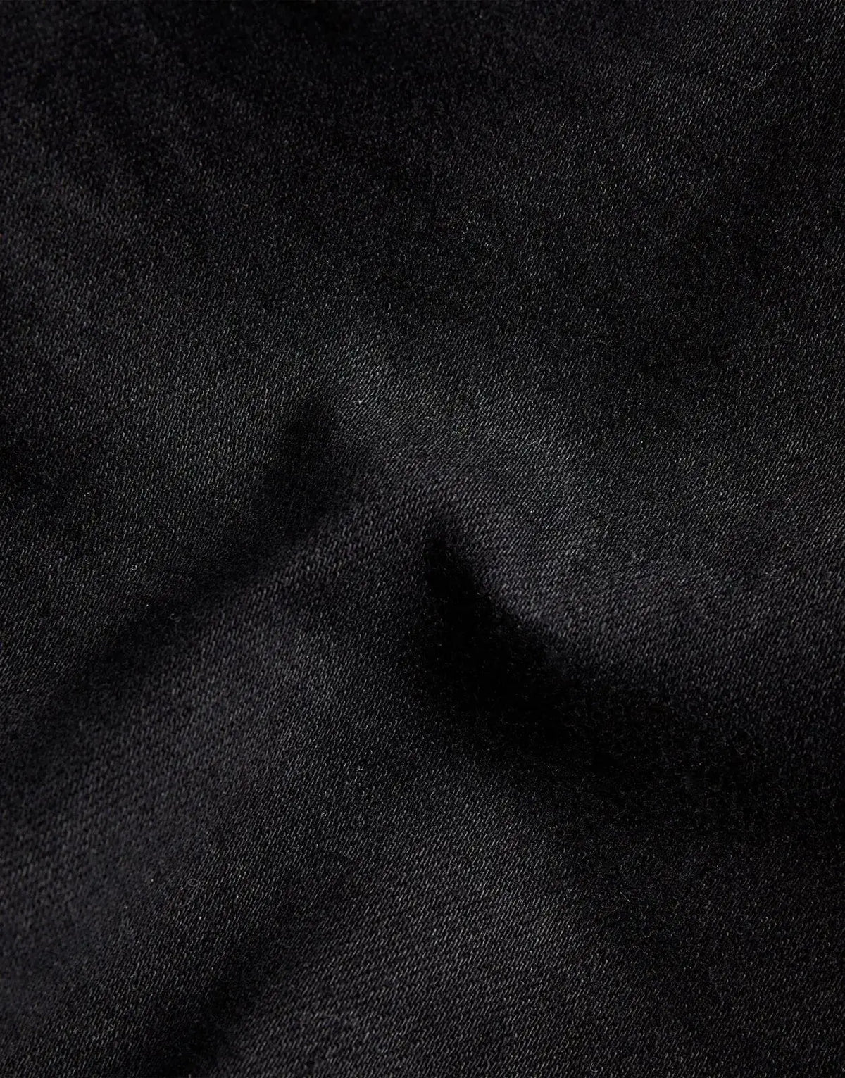 Close-up of G-Star RAW D-Staq 3D Jeans, showing dark denim fabric with visible texture and subtle folds.