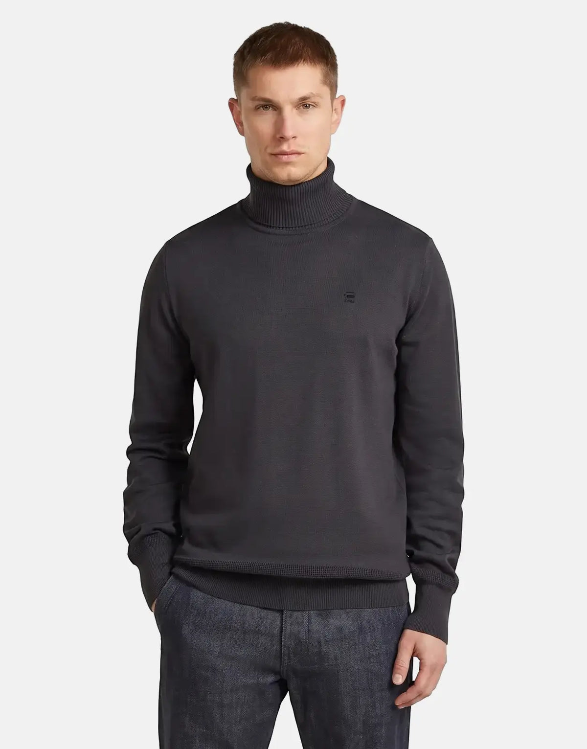 Male model wearing a dark gray G-Star RAW Regular Fit Asfalt Sweatshirt with a turtleneck, captured in a waist-up view.