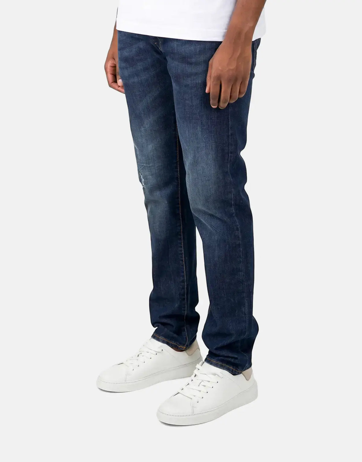 Les Hommes dark wash jeans in deep indigo denim, front view showing straight-leg fit and classic stitching.