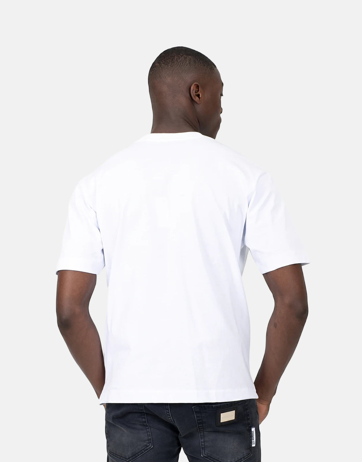 Les Hommes Dragonfly White T-Shirt on a male model, seen from the back wearing black jeans in a studio shot.