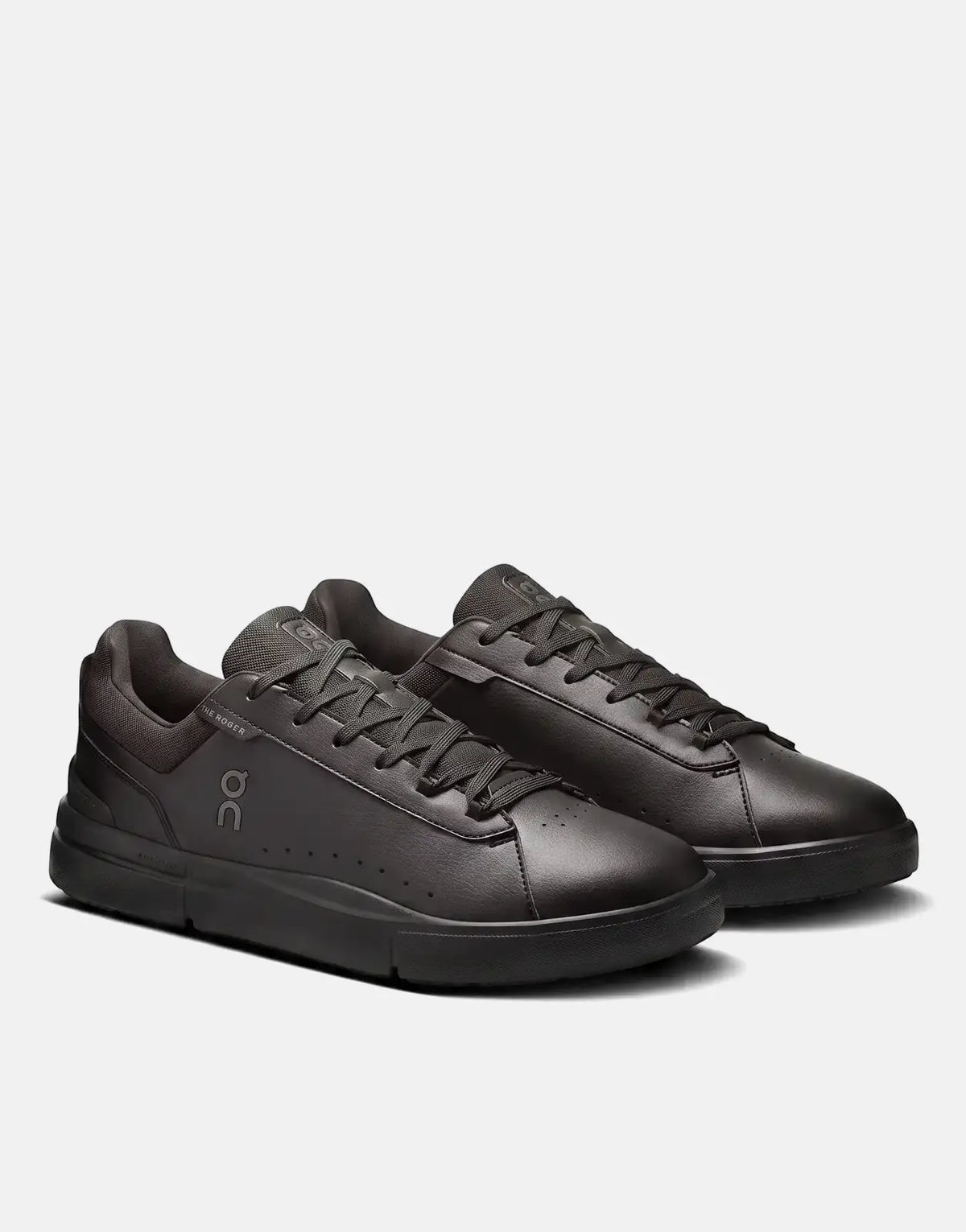 A pair of black On Men's Roger Advantage sneakers made of leather-like material, shown from a slightly angled side view.
