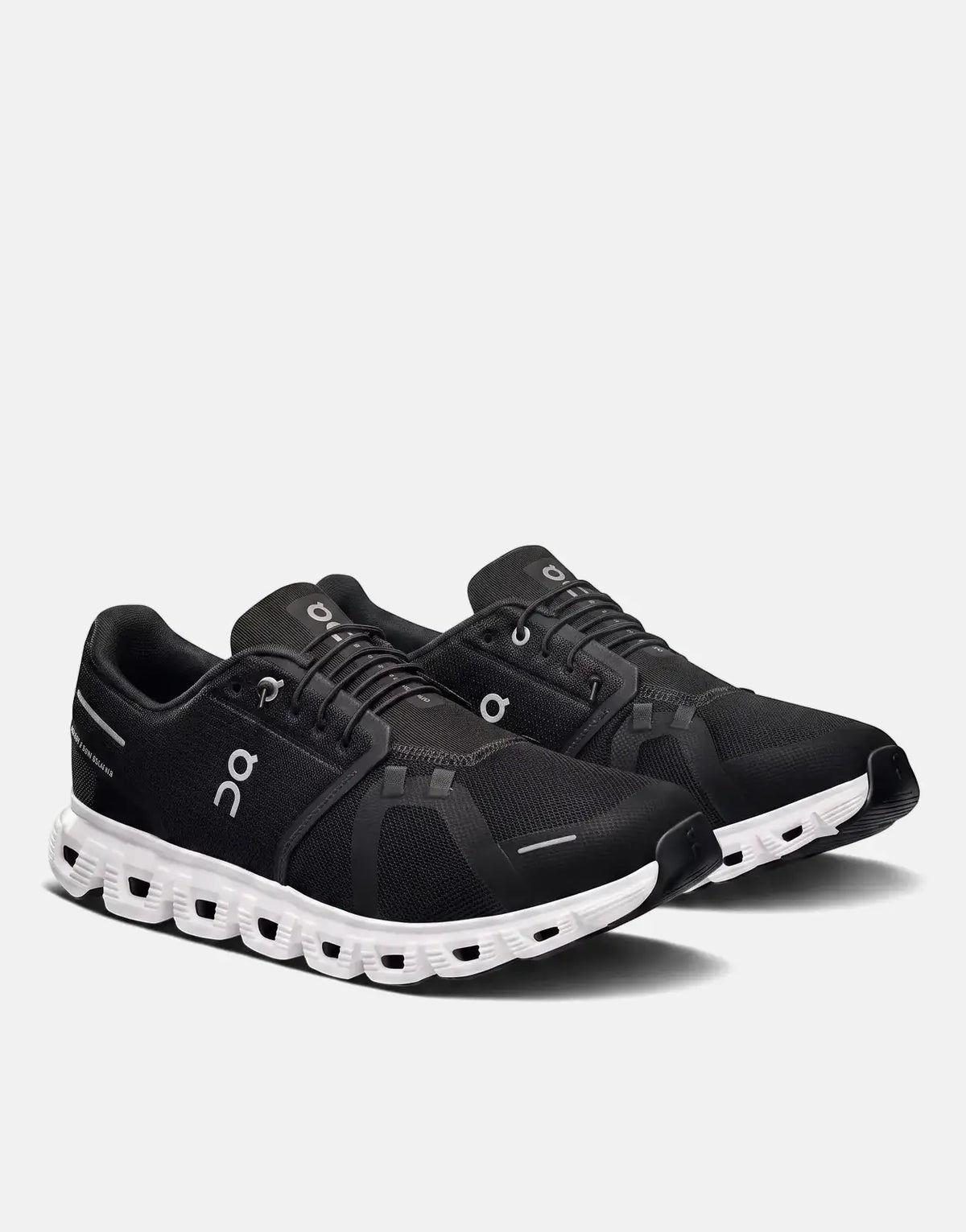Two black and white On Men's Cloud 6 running sneakers, featuring a black mesh upper and white cloud sole, shown at an angled