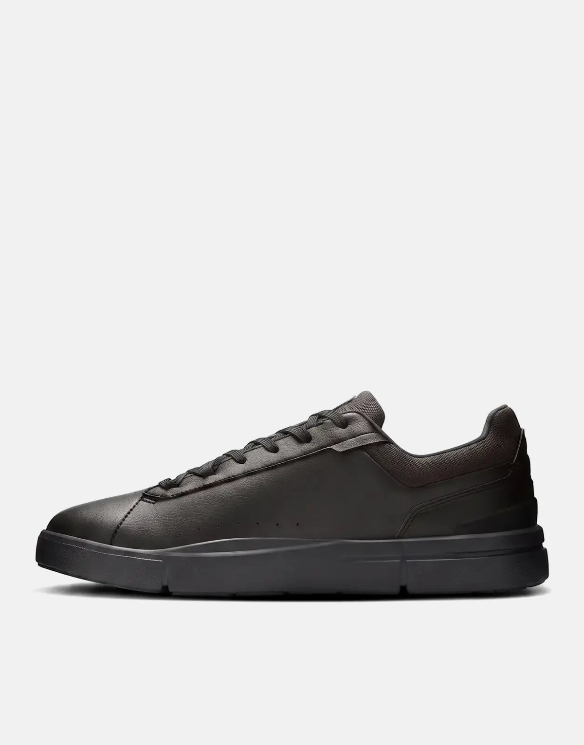 A side profile view of the On Men's Roger Advantage black leather sneaker with its distinctive ribbed sole and sleek design.