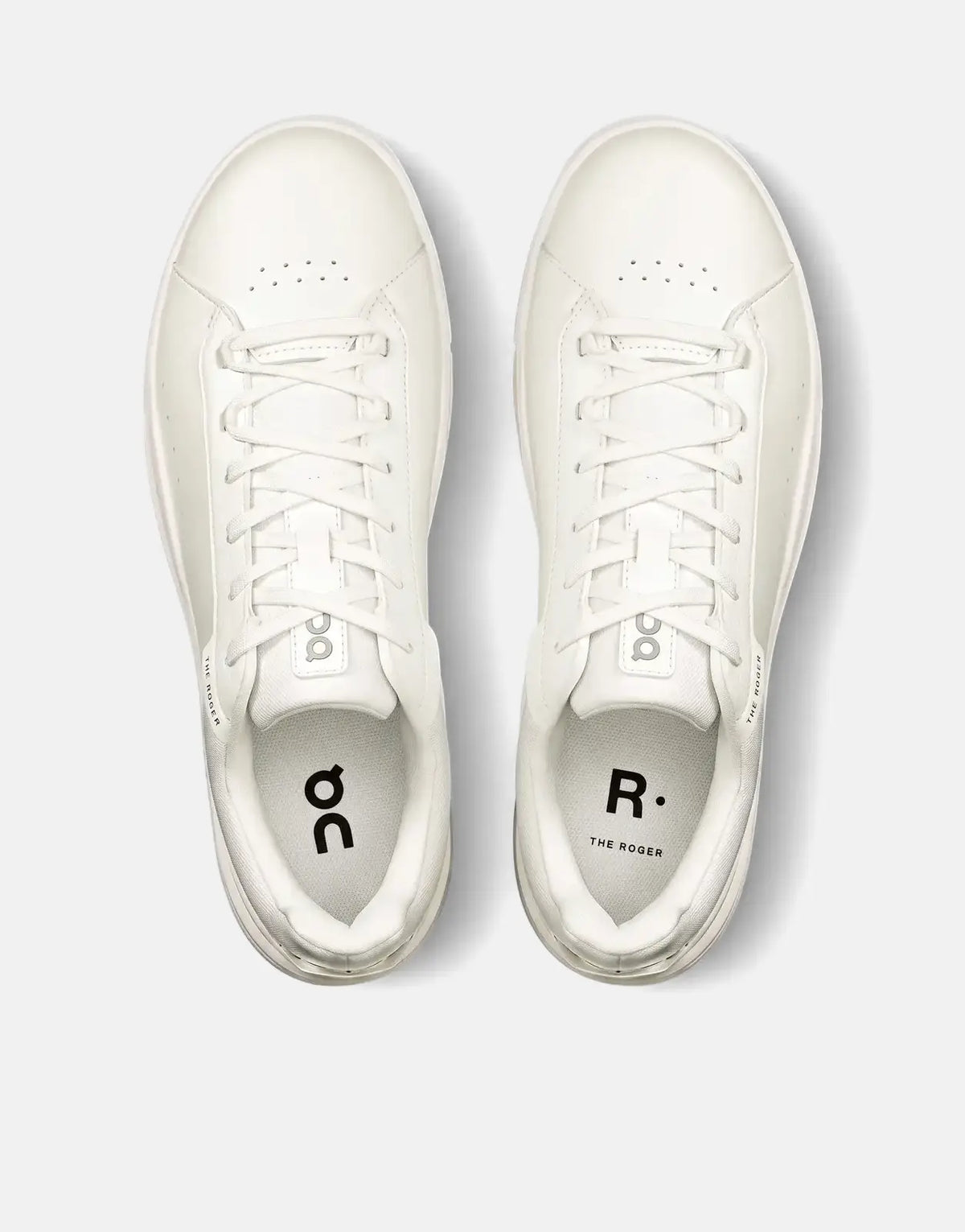 A top-down view of a pair of On Men's Roger Advantage white sneakers, featuring a clean low-top design with white laces and