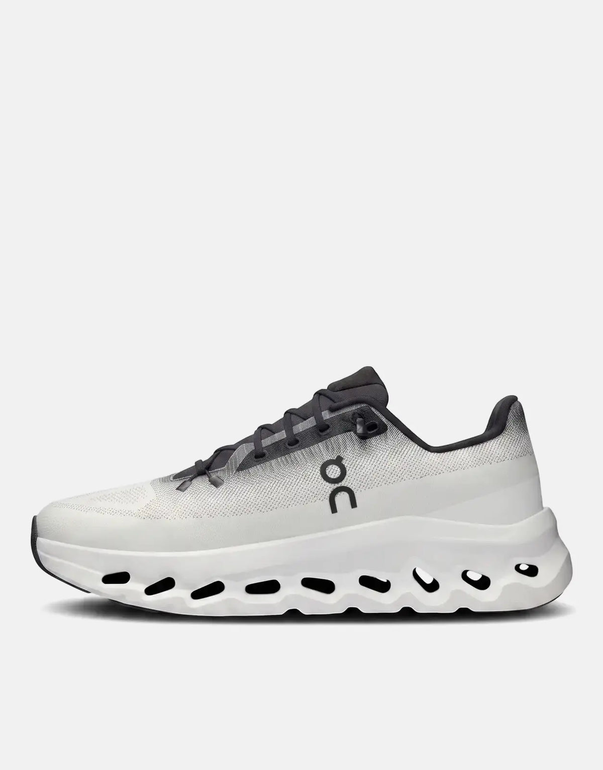 On Unisex Cloudtilt Black Ivory running sneaker in a profile view, featuring a white textured upper, dark gray laces, and a