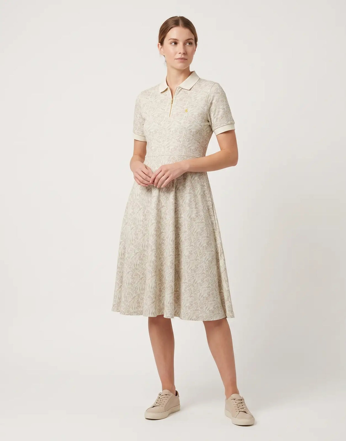 Polo Emily Fit & Flare Printed Multi Colour Golfer Dress, featuring a collared zip-neck and short sleeves, laid flat.
