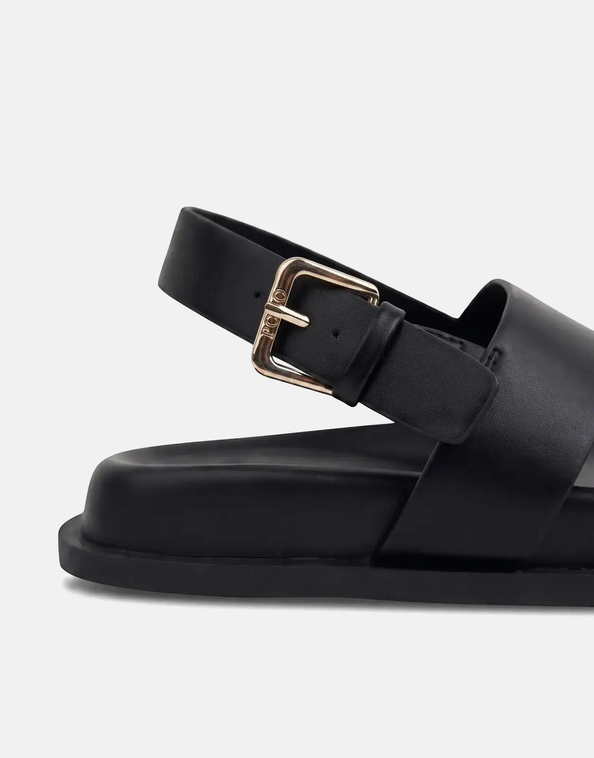 Close-up of a black Polo Moulded New Trim sandal, featuring a gold buckle and wide leather straps, on a white surface.