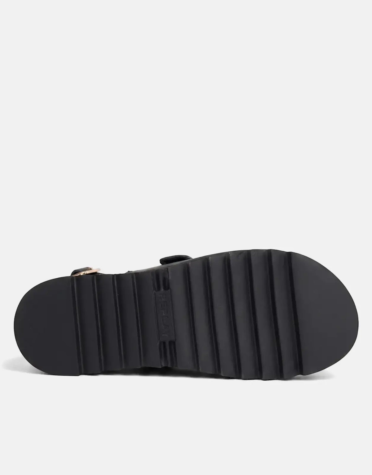 View of the black chunky ridged sole of a Replay New Alicante sneaker, featuring an embossed logo and a gold buckle.