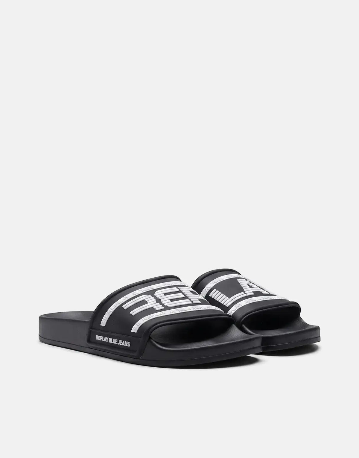 Pair of Replay Up Graven black and white slide sandals with bold white logo branding, showcased on a light background.