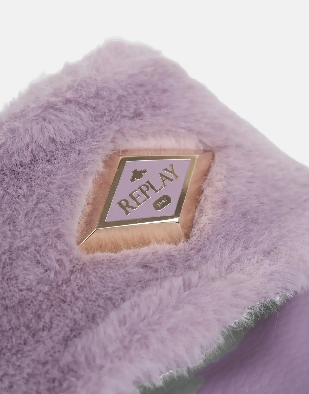 Close-up of a women's Replay Up W Along lilac faux fur slide sandal, featuring a prominent gold-rimmed 'Replay 1981' logo.