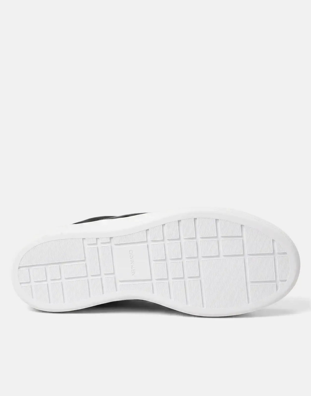 Bottom view of a black Calvin Klein Basket Pro sneaker with a white rubber sole, showing the grid pattern and embossed