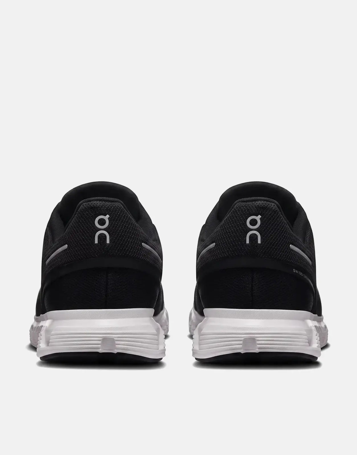 Black and white On Men's Cloud 6 sneakers, shown from the rear view, highlighting the heel and sole design.