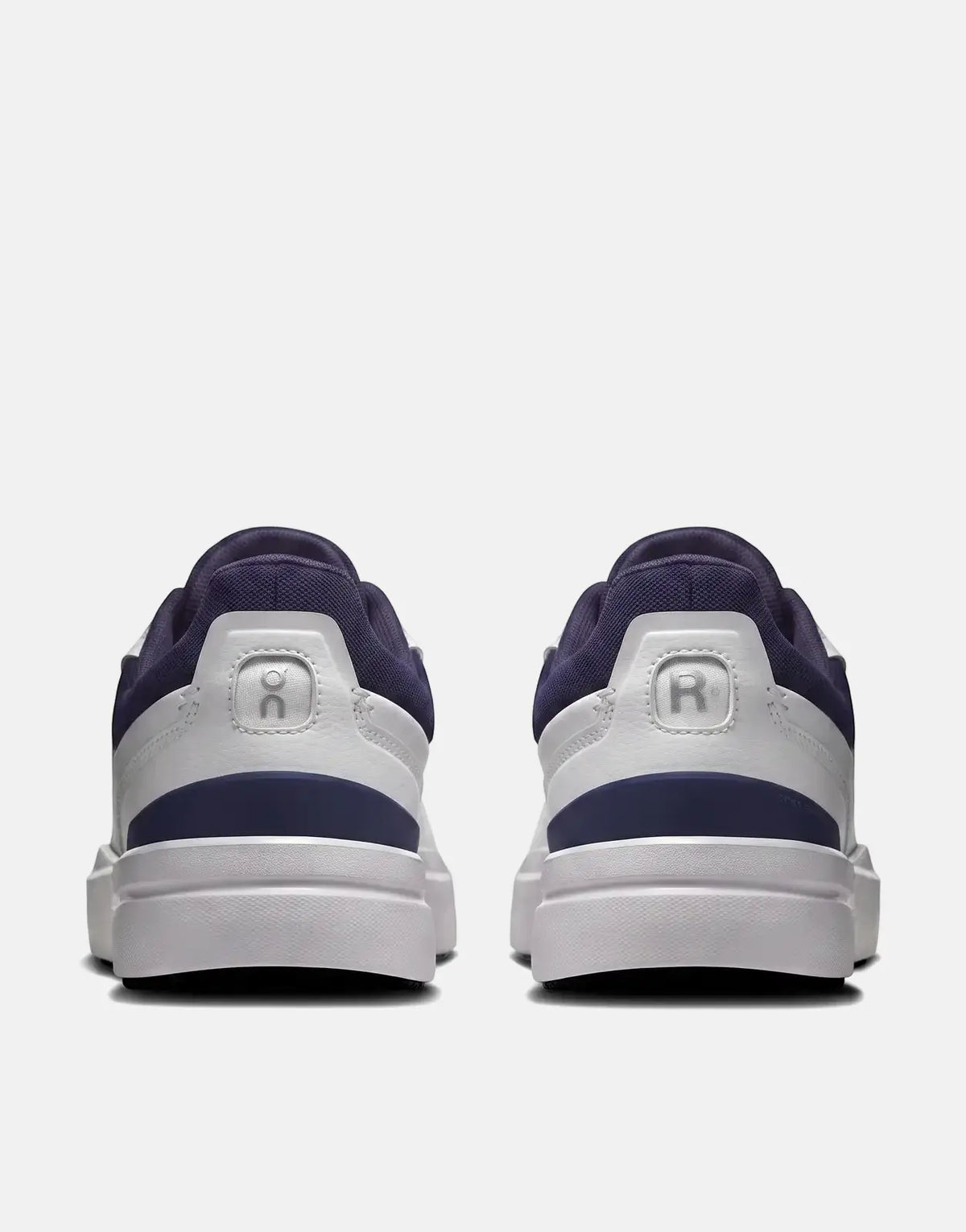 On Men's The Roger Advantage sneakers in white and midnight blue, shown from the rear view, highlighting the clean design.