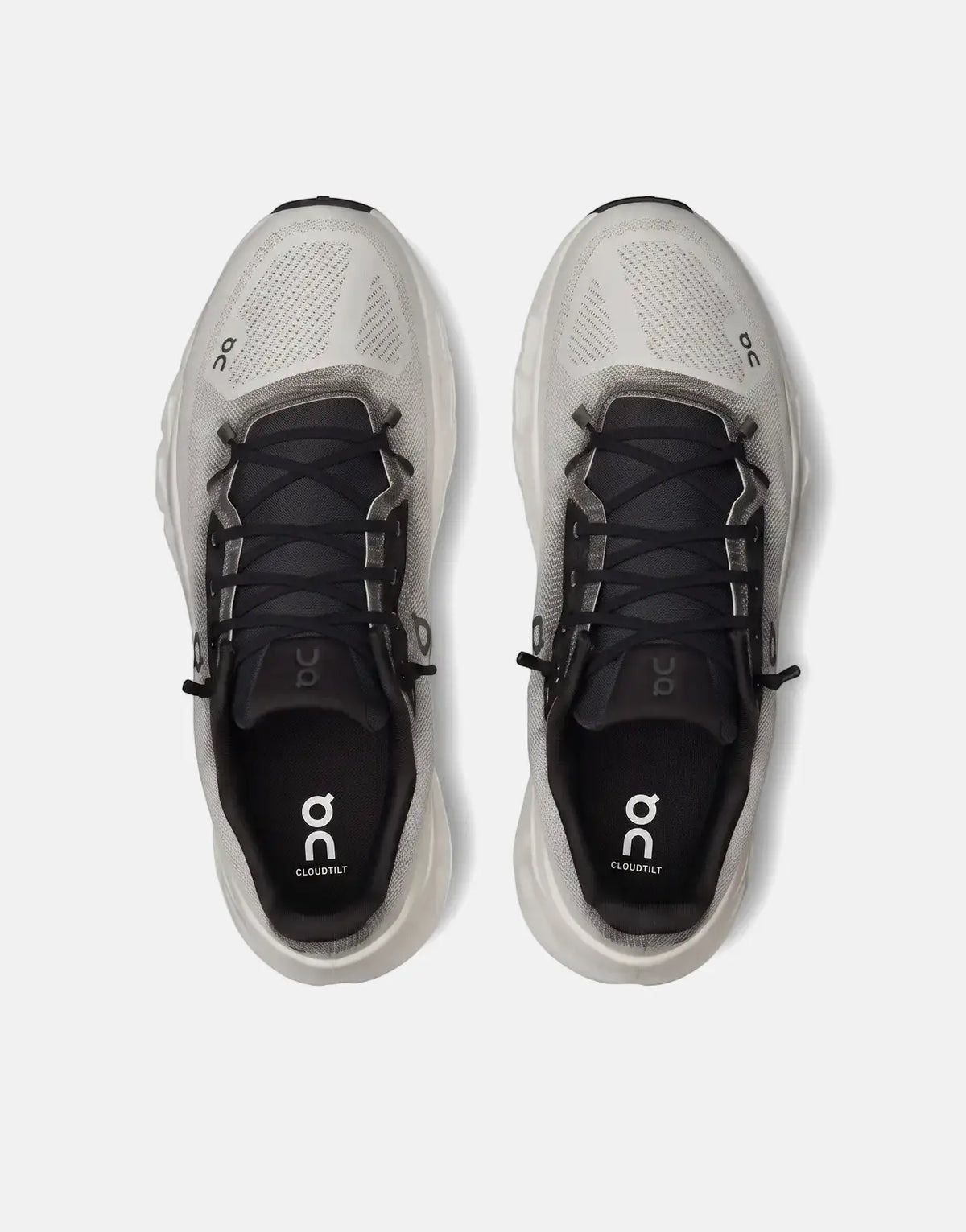 Top-down view of On Unisex Cloudtilt Black Ivory sneakers featuring a mesh upper, black laces, and cushioned sole.