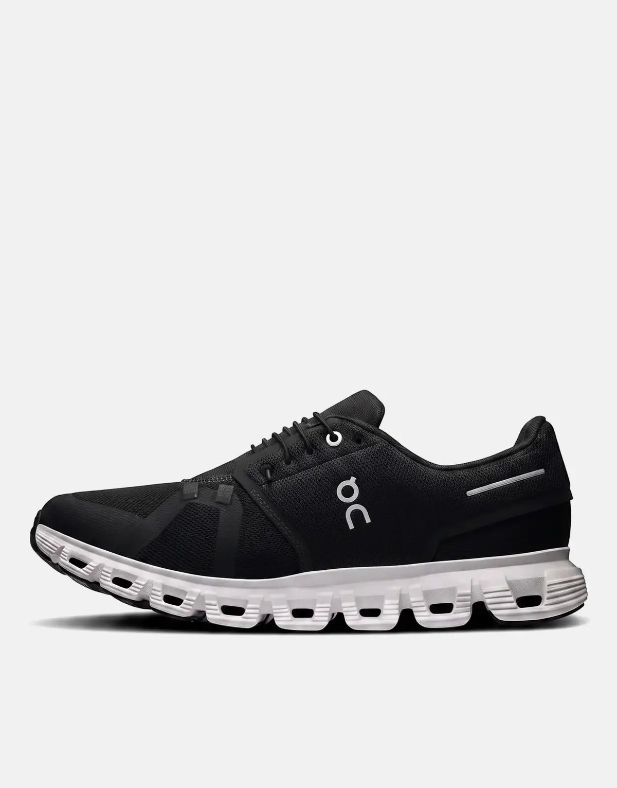 A black and white On Women's Cloud 6 running sneaker, viewed from the side, showcasing its unique sole design and white