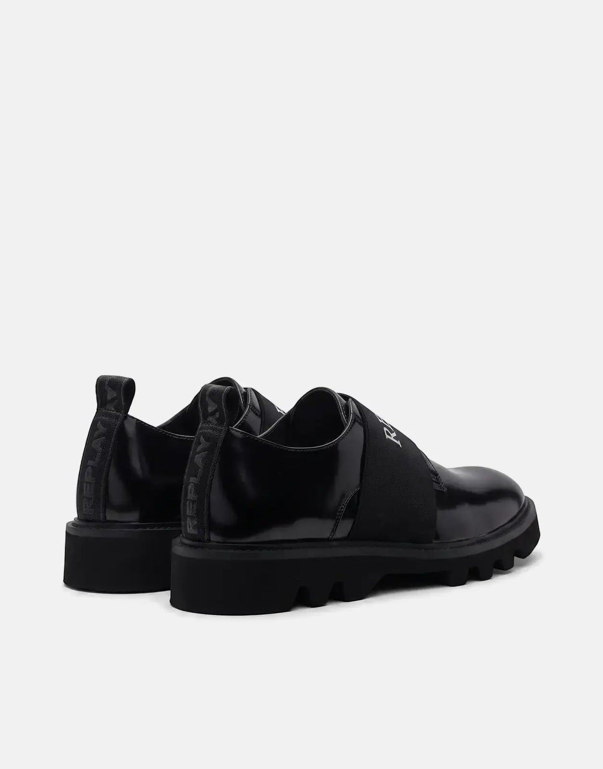 Pair of Replay Canver Brush SA sneakers in black patent finish with chunky lug soles and white logo branding.