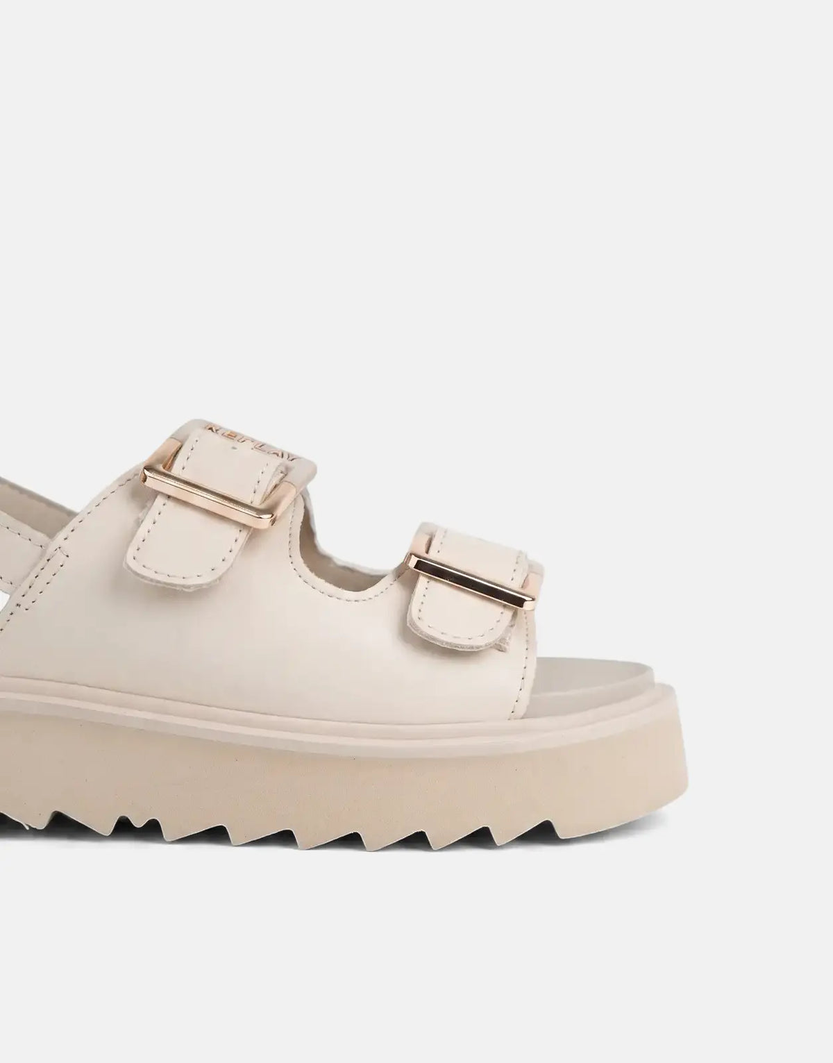 Close-up of a single Replay New Alicante beige platform sandal with gold buckles and a chunky, jagged sole.