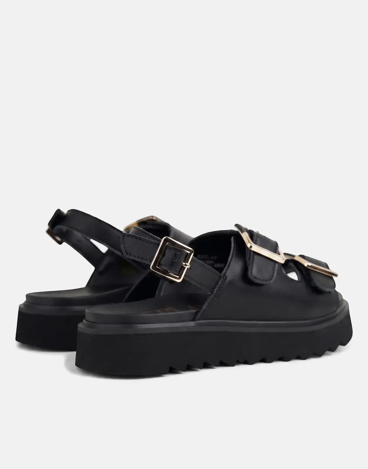 Close-up of a pair of Replay New Alicante black platform sandals with gold buckles, angled view.