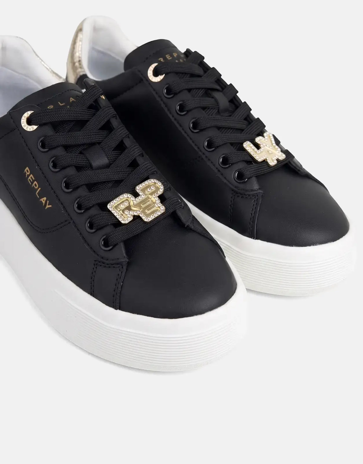 Close-up of Replay Notting W Image black sneakers with white platform soles, gold eyelets, and crystal-studded charms on the