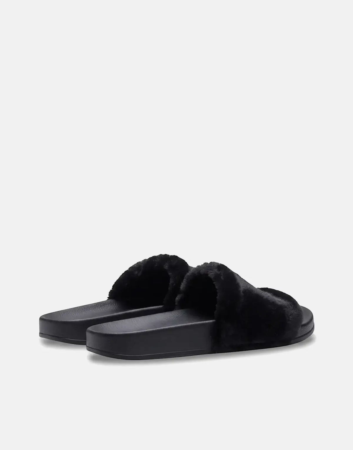 A pair of Replay Up W Along black fluffy slides with a solid sole, positioned on a light gray background.
